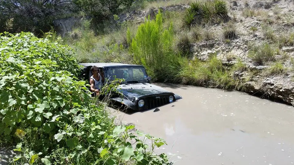A jeep deep in water. 
