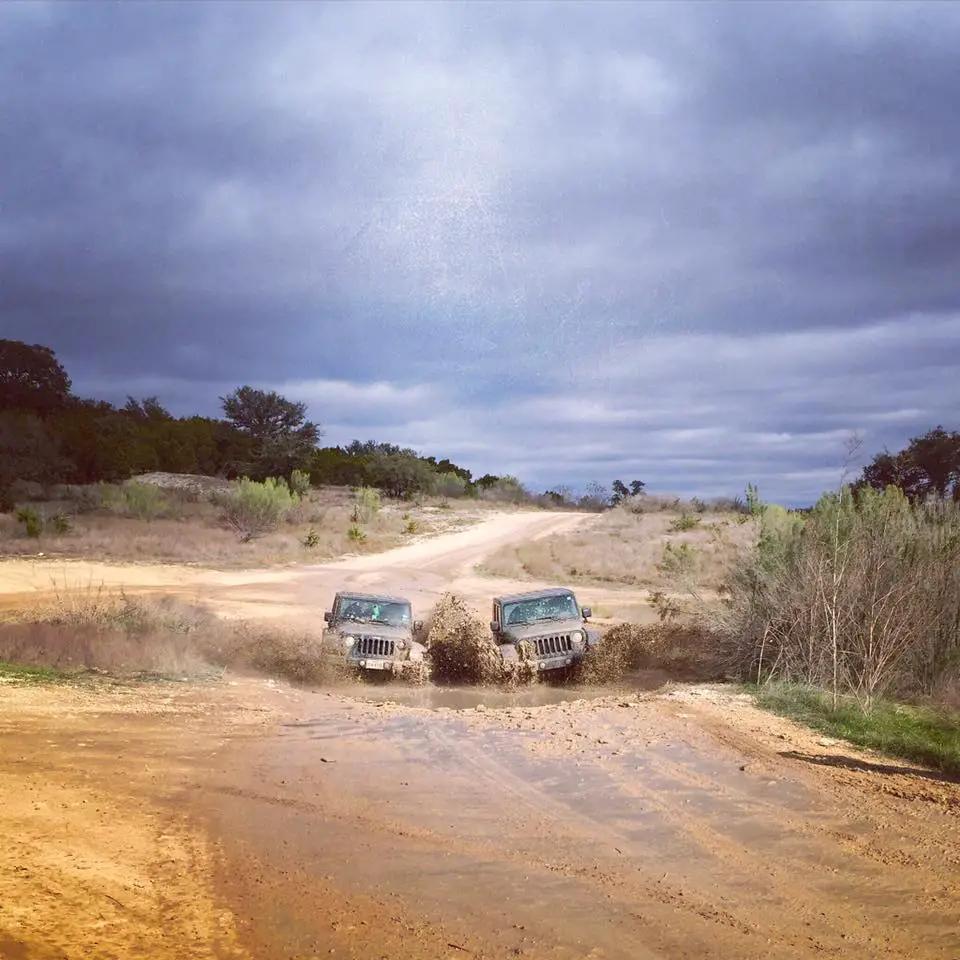 Two jeeps racing in the mud