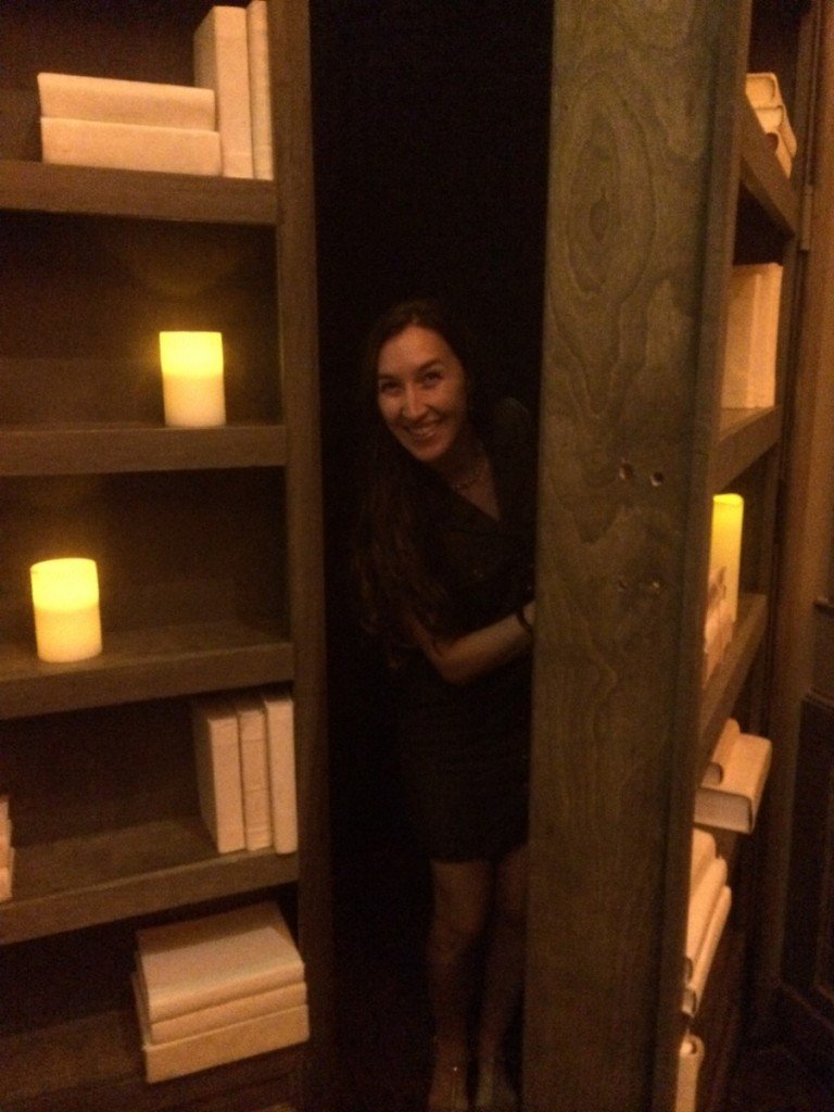 A hidden bookcase reveals a bar inside a bar