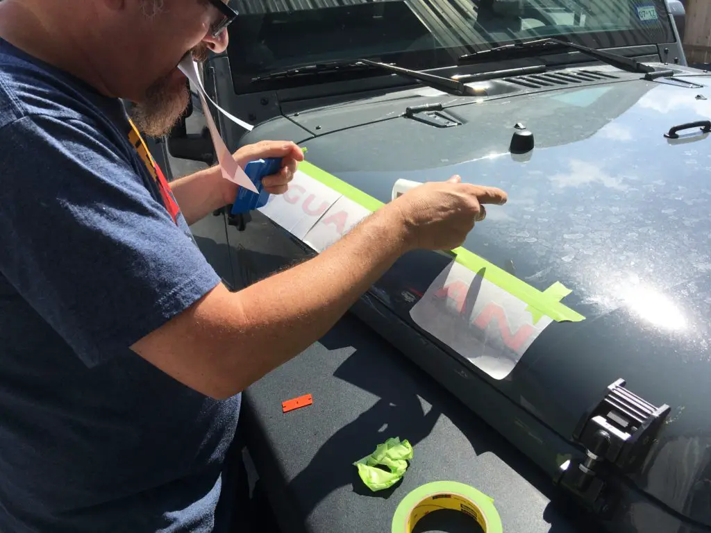 cutting decals for installation on a Jeep