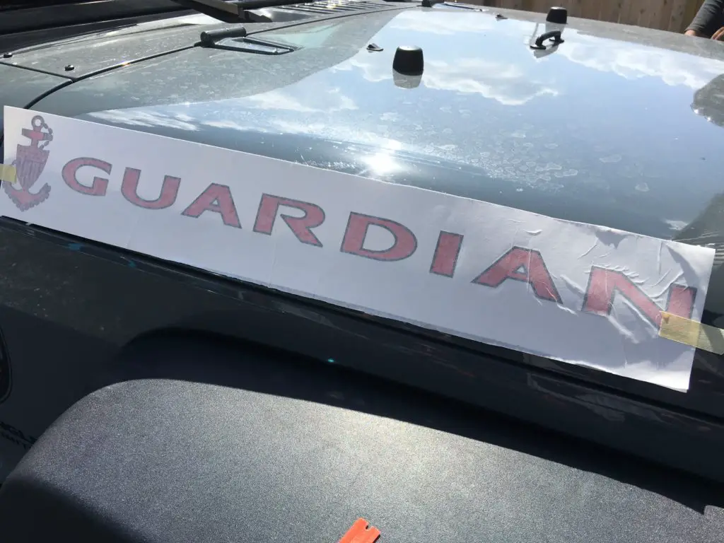 a decal in position about to be installed on a Jeep