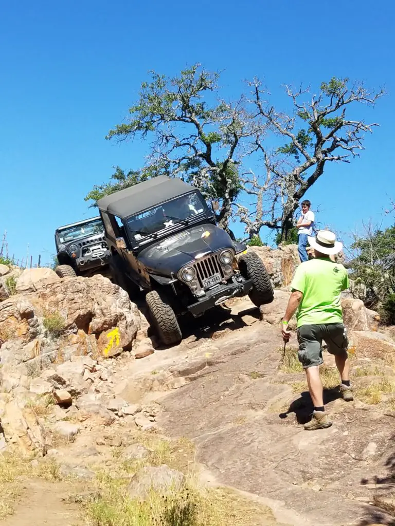 Trail guides guiding Jeepers through obstacles