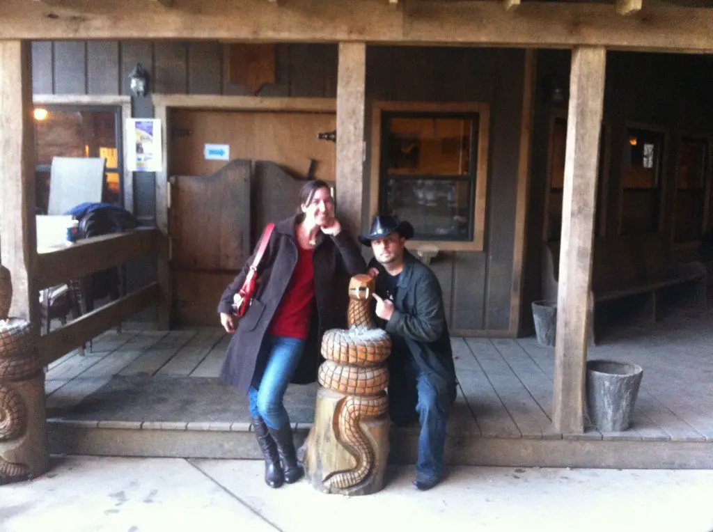 Eric and Brittany of RV Wanderlust in front of the entrance to the Rattlesnake Saloon