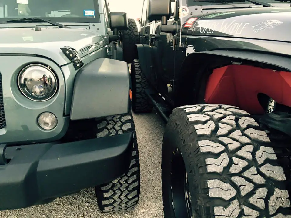 Two Jeeps parked really close to one another. 