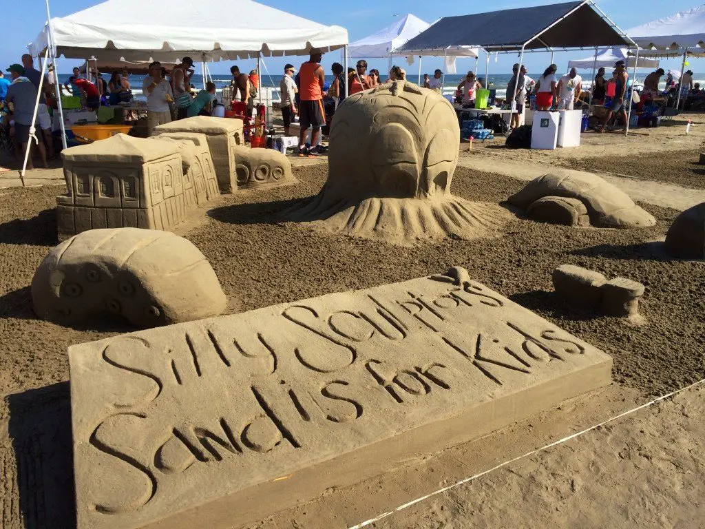 A funny sandcastle reminder that sand is for kids
