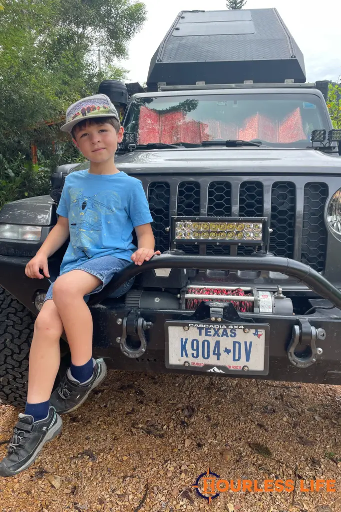 Kid driving around the world in a Jeep with his family