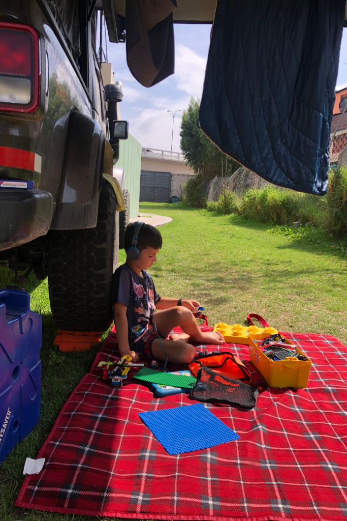 Caspian Highland Playing Outside Jeep